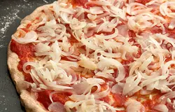 Поверх соуса равномерно разложите лук. Чем больше лука, тем вкуснее получается.