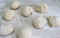 Стол посыпать мукой и разделить тесто на 8 частей.