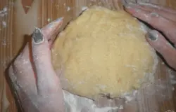 Постепенно вводим муку, соду и лимонную кислоту. Вымешиваем тесто, оно должно не липнуть к рукам, но не стоит его и забивать