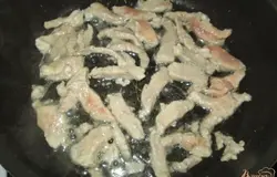 Мясо нарезаем на тонкие полосочки, выкладываем на сковороду с растительным маслом