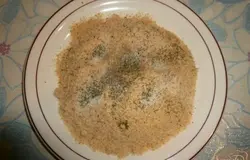 Панировочные сухари высыпаем на сухую плоскую тарелку, добавляем к ним сушеный укроп, сушеный чеснок, немного черного молотого перца и четвертую часть чайной ложки соли, перемешиваем.