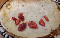 Клубнику нарежьте дольками и выложите на одну сторону блинчика. Сверху полейте немножечко совсем сливочным соусом.
