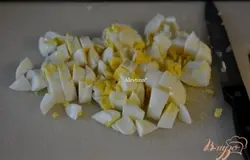 Отварим картофель, яйца. Картофель очистим и порежем кубиками. Также очистим яйца и порежем.