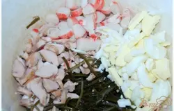 Смешиваю маринованную морскую капусту, порезанные молоки, яйцо и крабовые палочки.
