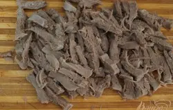 Нарезать соломкой отварной язык.